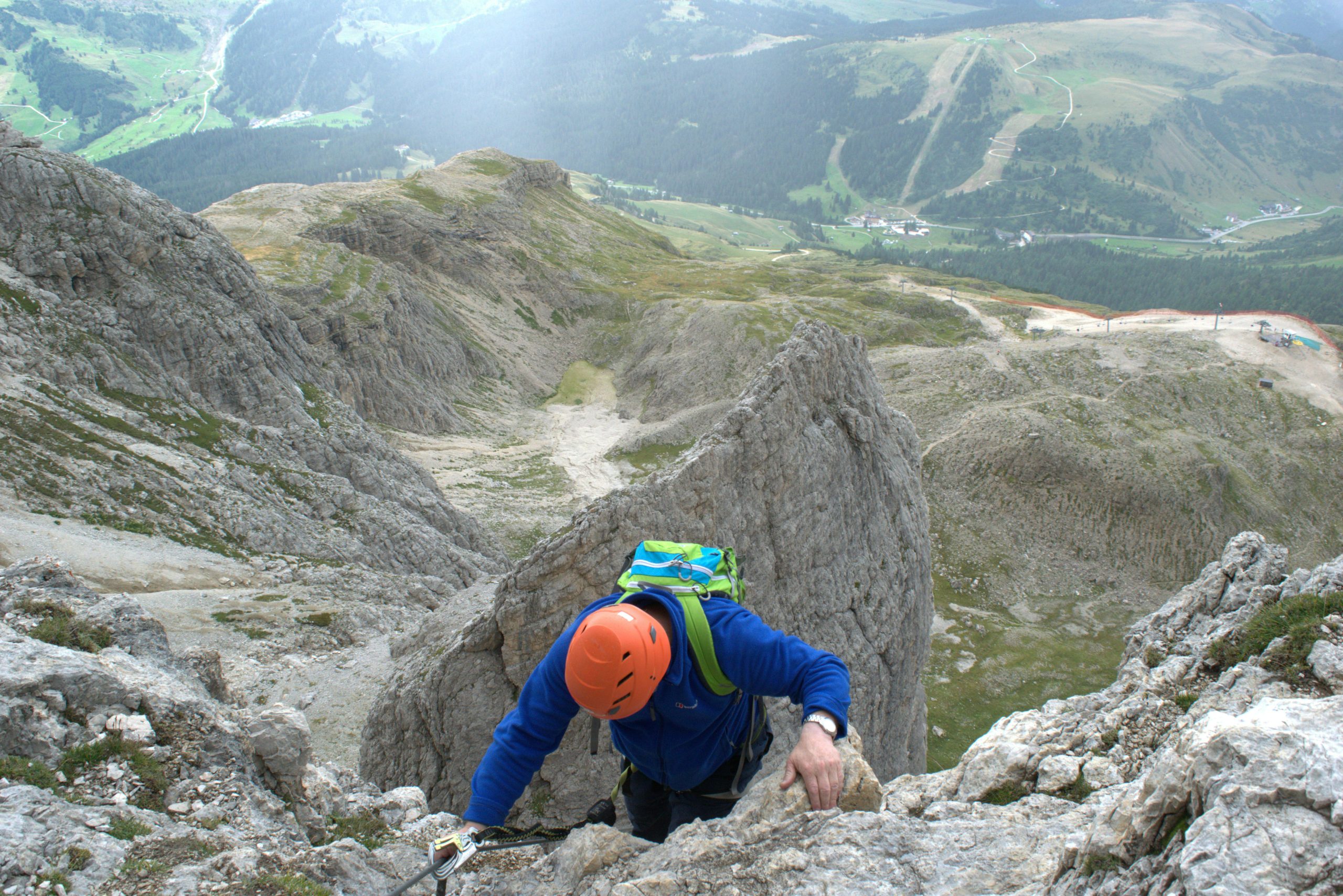 A climber makes their ascent up a rocky mountain in Veneto, Italy, showcasing adventure and skill.